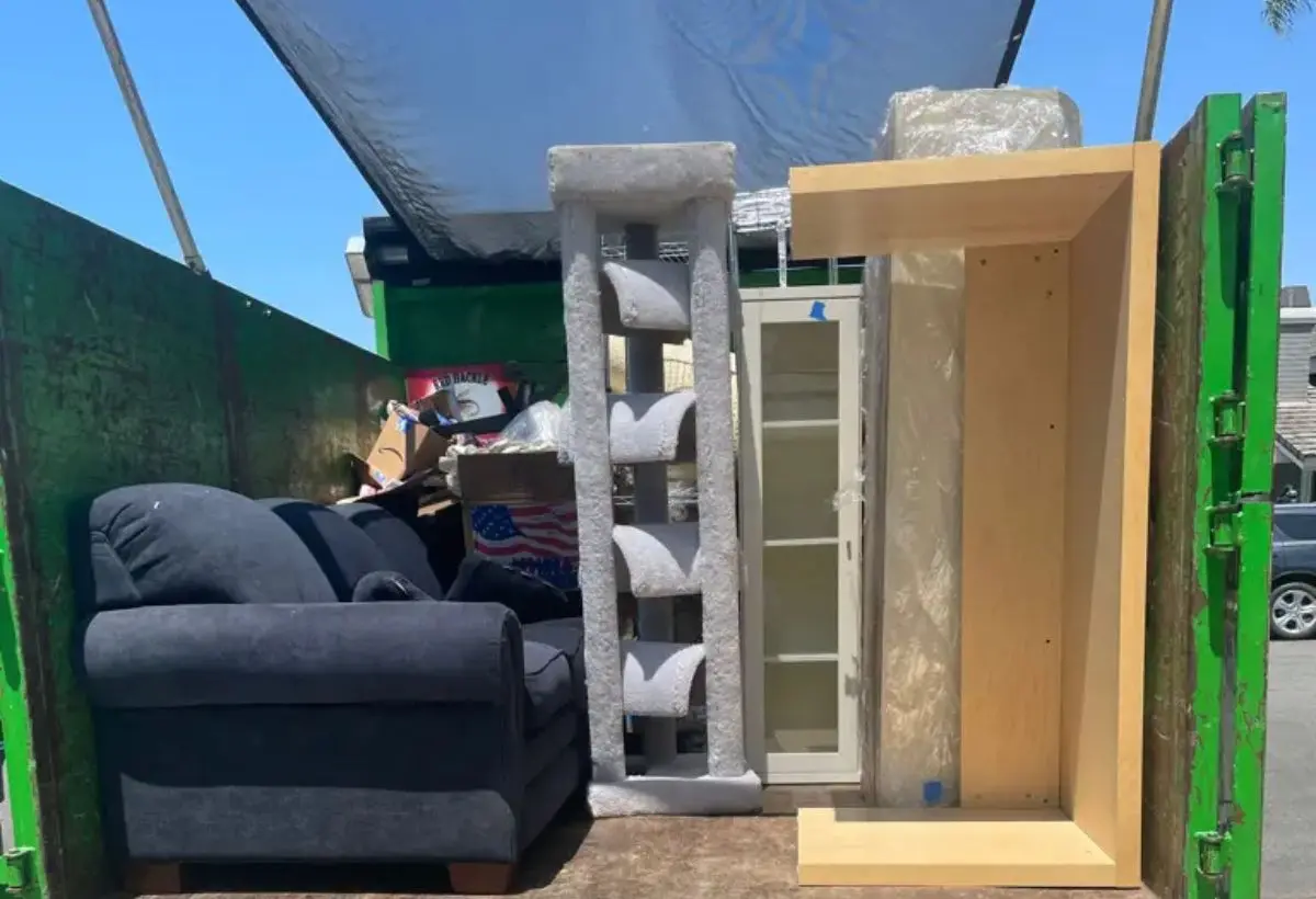 dumpster truck with old furnitures